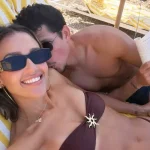 Jessica Alba and Danny Ramirez relaxing together on a beach during their Italian getaway.