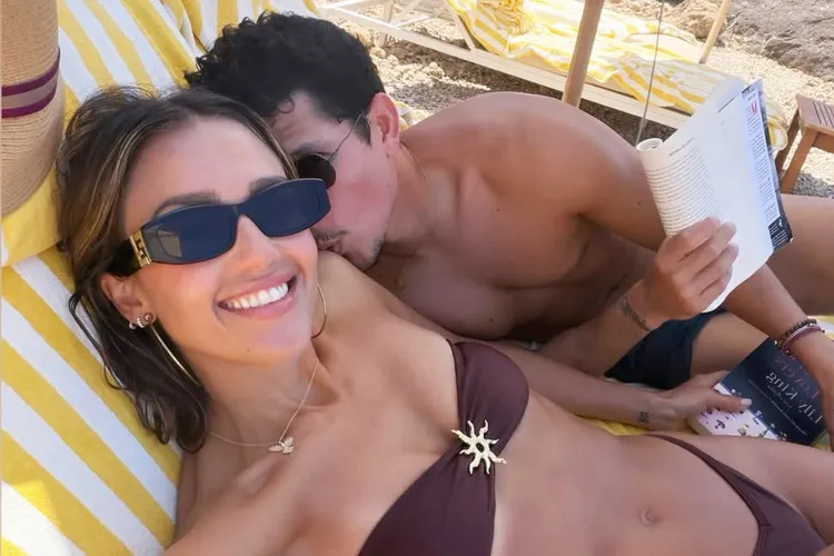 Jessica Alba and Danny Ramirez relaxing together on a beach during their Italian getaway.